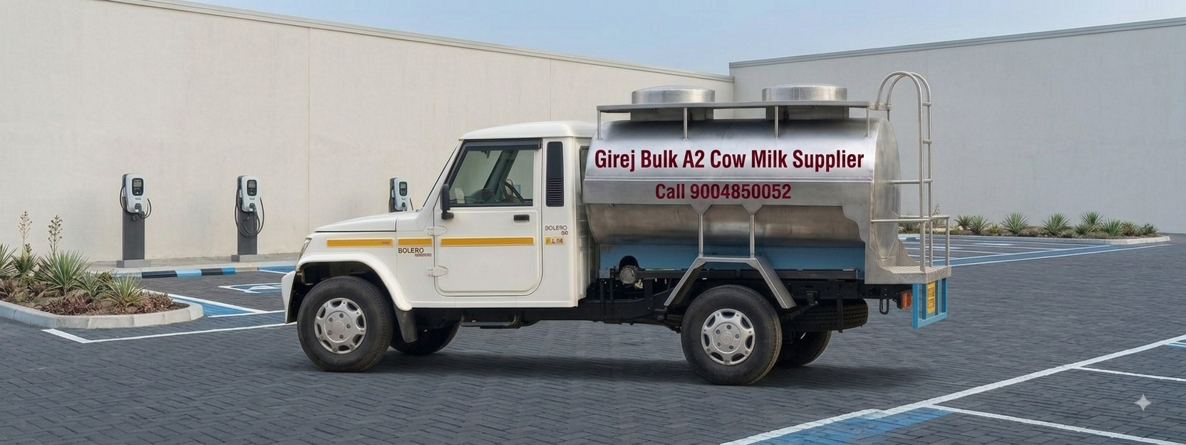 Girej bulk A2 cow milk supplier stainless steel milk tanker mounted on a Bolero pickup at a dispatch yard in Gujarat